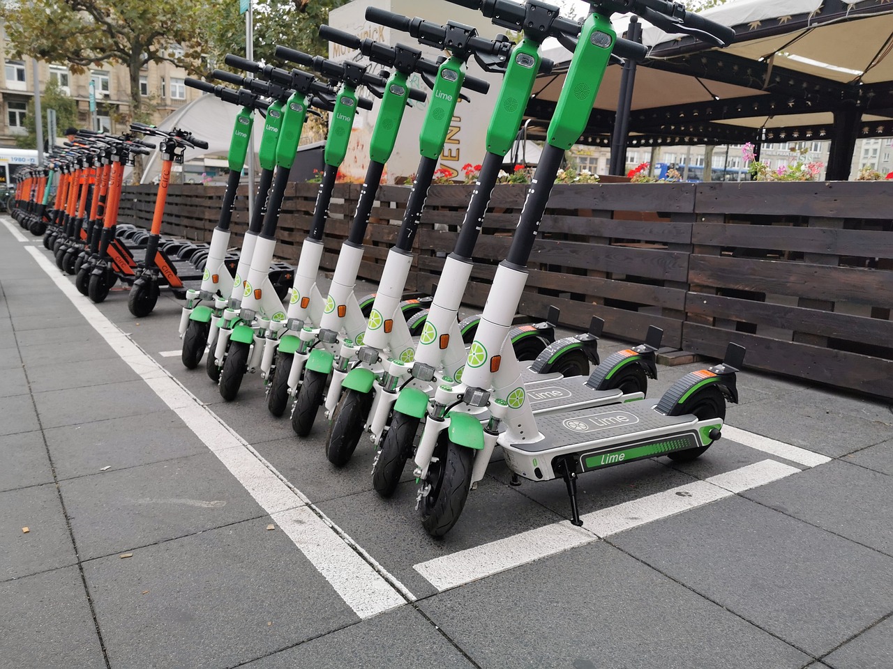 electric scooters of popular brands stands on the street to rent