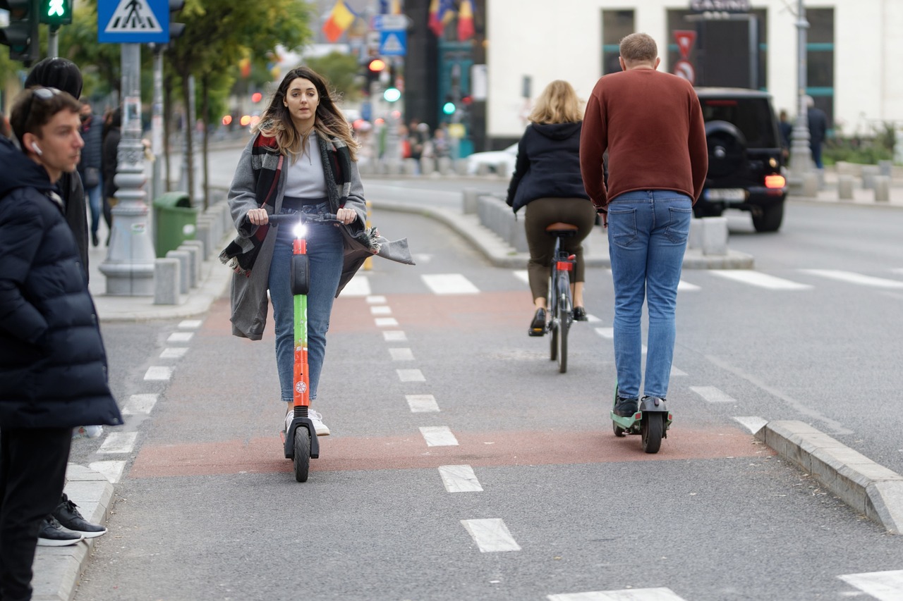 people ride electric scooter in opposite ways in bike road line with turning on lights