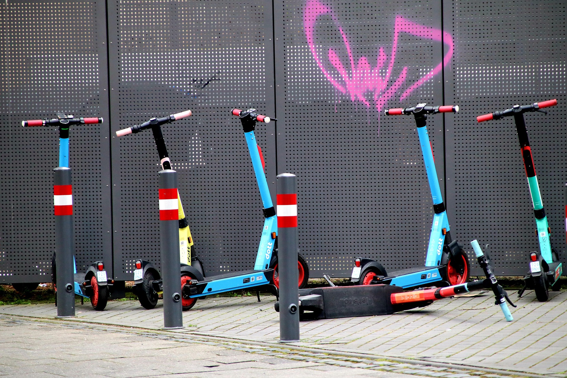 electric scooter parked neat wall with graffiti paints