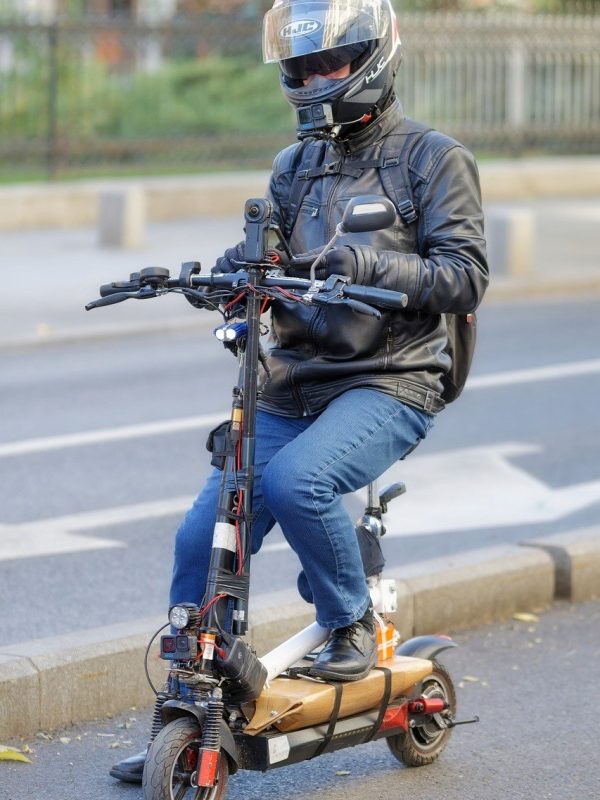 man ridding powerful e-scooter with additional features