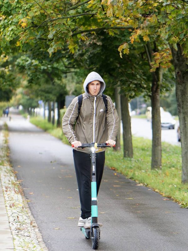 boy rides an electric scooter on high speed mode