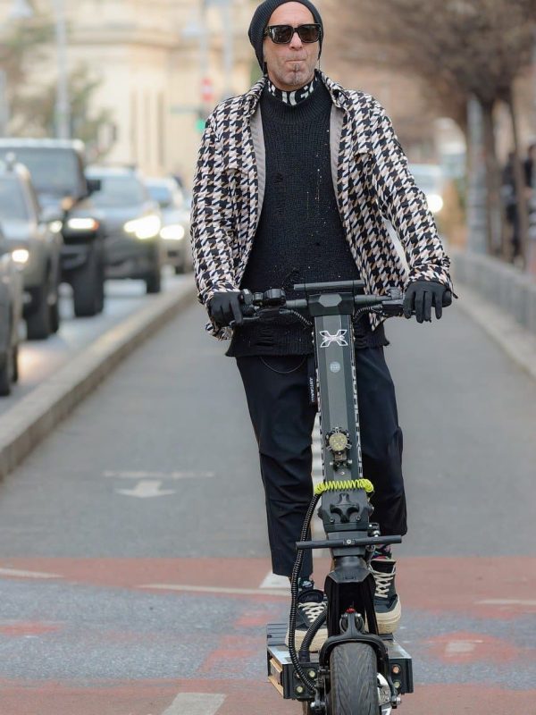 man rides powerful electric scooter with high top speed