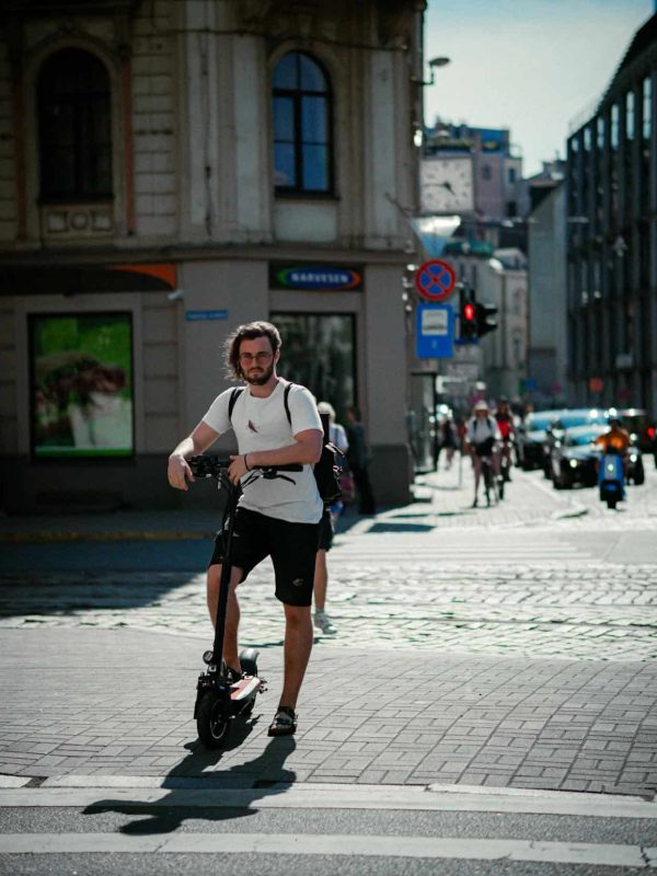 man take his new e-scooter into streets