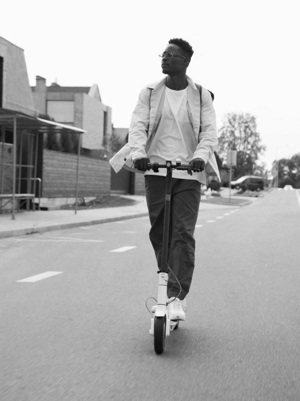 Are electric scooters permitted on the road? man is ridding electric scooter on the road with no cars