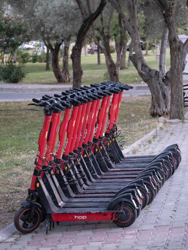 electric scooters parked on the street and you can pick one and rent it